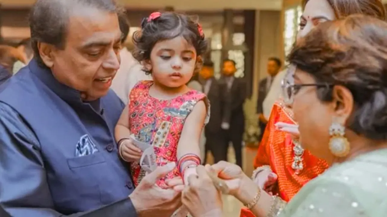 Little Veda Ambani in orange lehenga at celebrity wedding